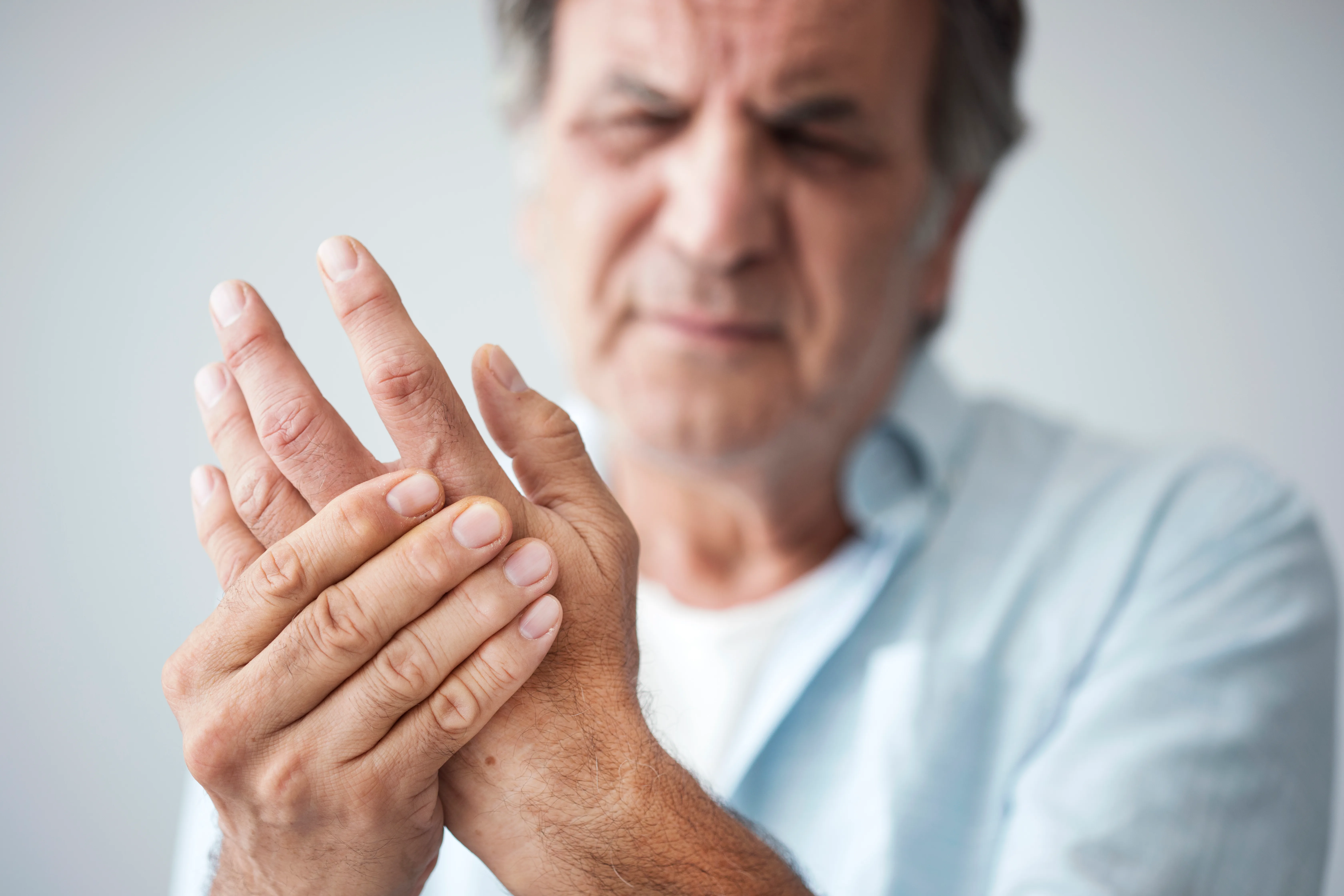 What is Trigger Finger - Man holding his hand in pain