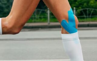 injection therapy for runners - image of a female runners legs with strapping on.