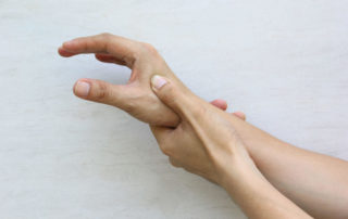 first cmc - Thumb joint osteoarthritis - a hand holding its other hand.