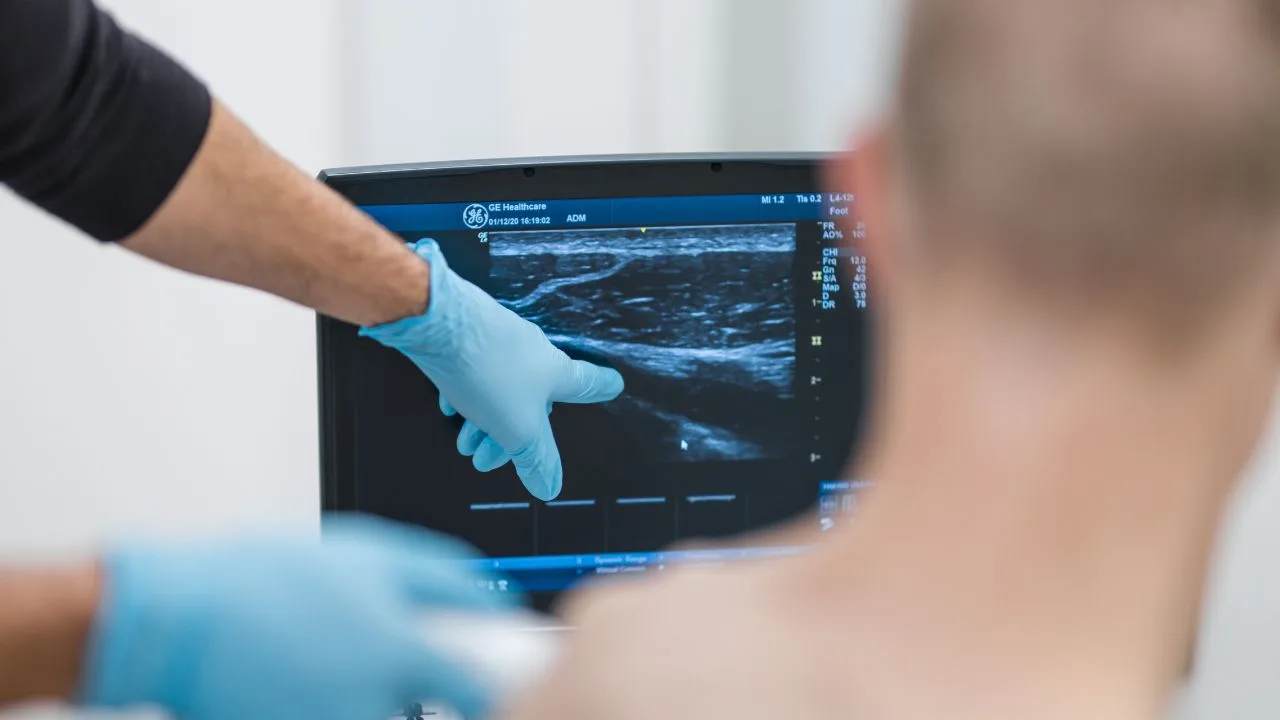 A Complete Injections clinician reviewing a diagnostic ultrasound scan